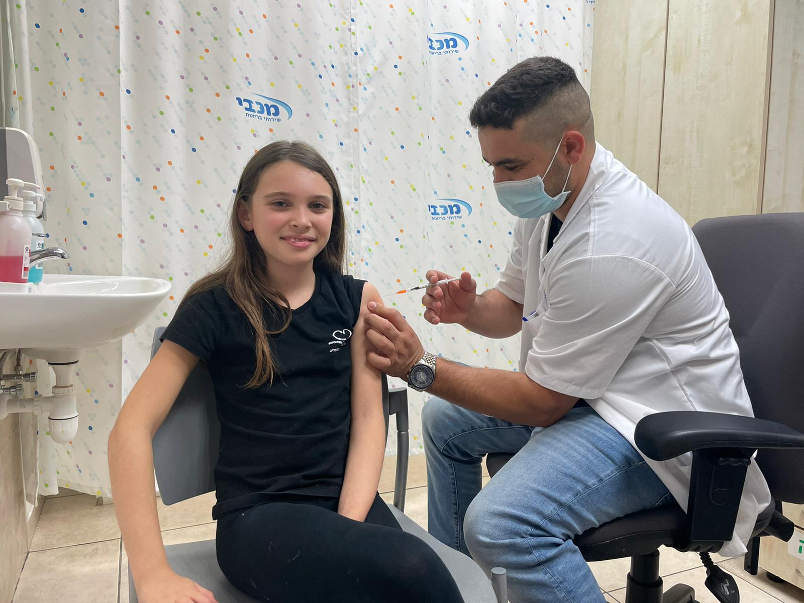 A child receives a vaccine through the Maccabi Health Fund in Israel in December 2021.