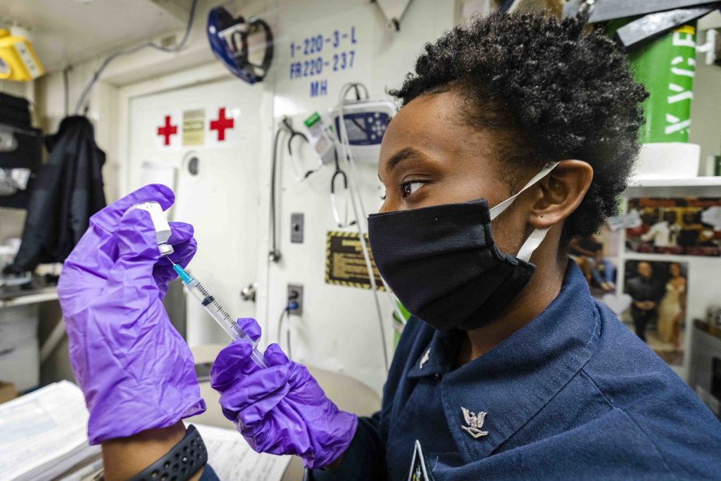 A hospital corpsman prepares a flu vaccine