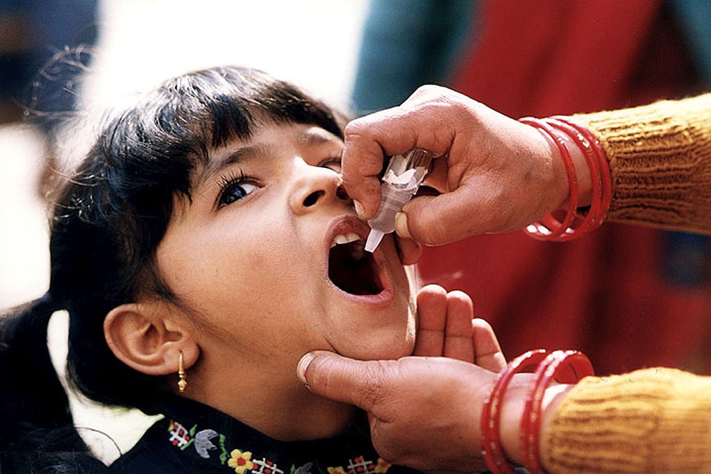 Girl receives oral polio vaccine, funded by Gates Foundation philanthropy