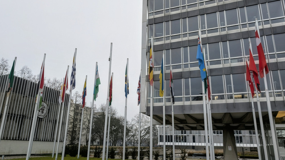 The missing US flag at WHO headquarters reflects the deep budget crisis and ongoing workforce restructuring.