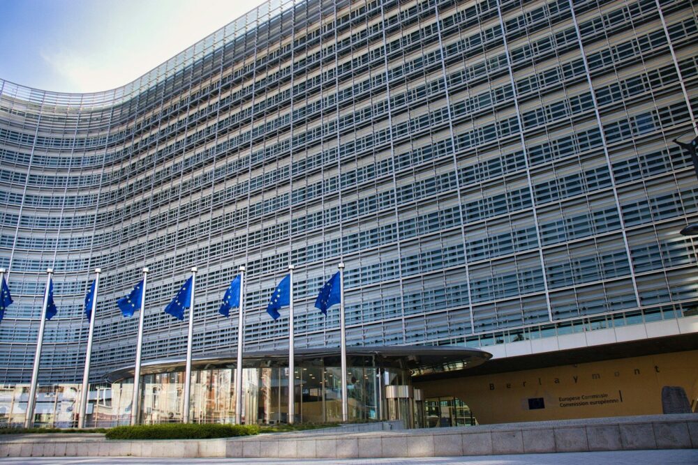 Modern glass building with European Union flags