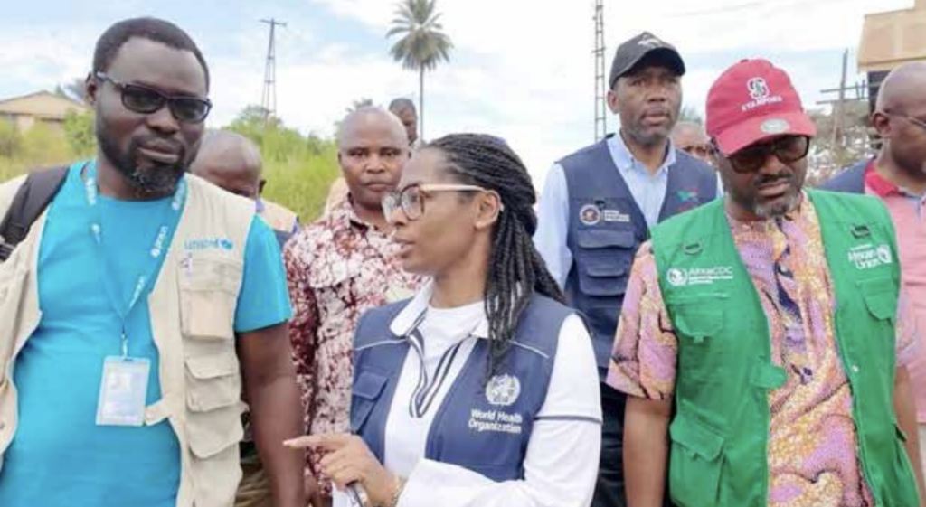 WHO's Dr Roseline Belzaire (centre) and Africa CDC's Dr Yap Boum on the ground in Ituri in the DRC.
