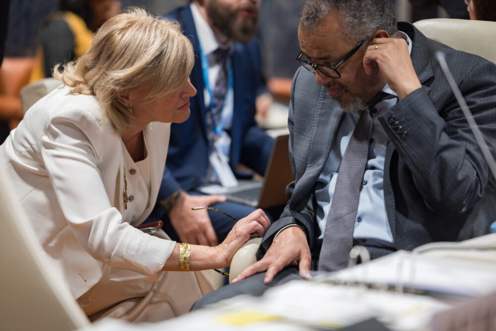 Dr María Neira confers with WHO DG Dr Tedros during the 2025 World Health Assembly in Geneva. Her last-minute nomination will likely focus on climate and health.